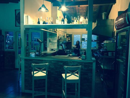 a woman sitting at a bar with two chairs at Posada rural el rincón de Cabrojo in Cabrojo