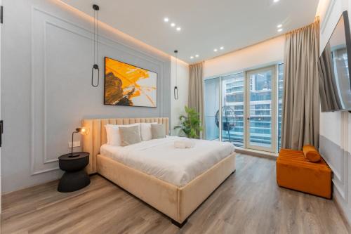 a bedroom with a large bed and a large window at Vacationer Holiday Homes I Stunning 4 Bed I 10 Min from Marina Mall in Dubai