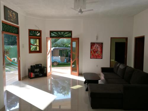 a living room with a couch and a table at Guesthouse Dilush in Beruwala