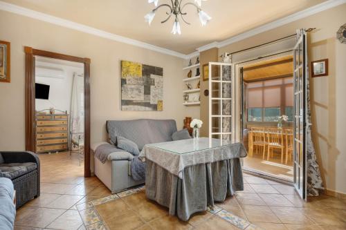 a living room with a couch and a table at Rural El Santiscal in Arcos de la Frontera