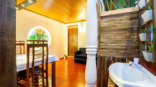 a bathroom with a sink and a toilet in a room at Sansevieria Homestay in Sigiriya