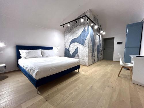 a bedroom with a bed and a painting on the wall at Residenza Basiglio in Ceva