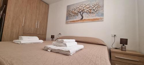 a bedroom with two beds with towels on them at Sa Omu de S'Olia in Tertenìa