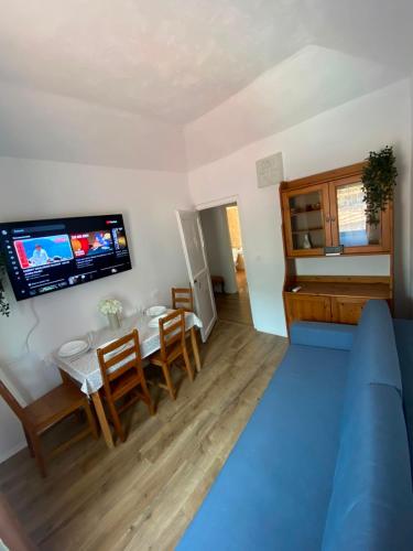 a living room with a table and a tv on the wall at Casa Tre Fiori 3 in Mignanego