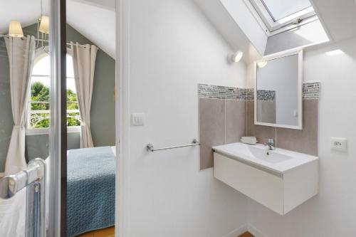 a bathroom with a sink and a mirror at Les Soliers in Étretat