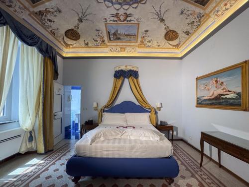 a bedroom with a bed with a coffered ceiling at Garden Palace Hotel in Castiglione del Lago