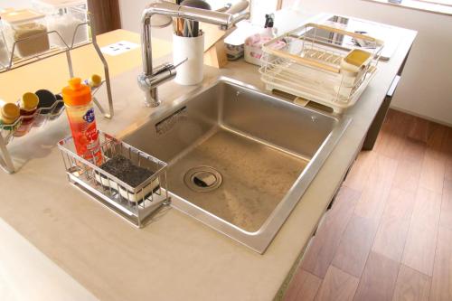 a kitchen sink with a dish rack next to it at The Glow Omachi B棟 in Omachi