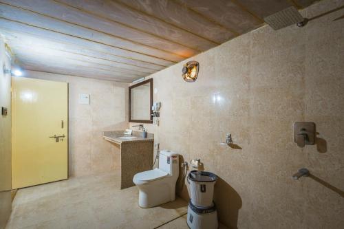 a bathroom with a toilet and a sink at Rojani Resort in Sām