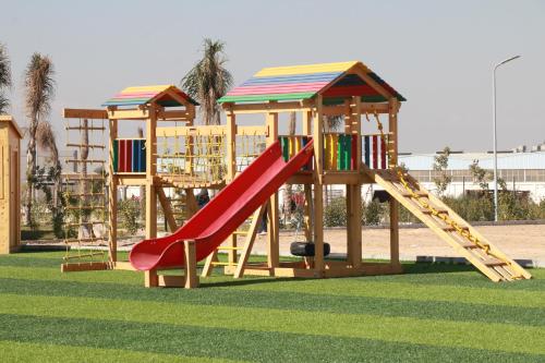 a playground with a slide and a play structure at The Guard Hotel in Cairo