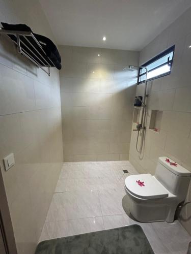 a bathroom with a toilet and a shower at Matirina Ura lodge in Arue