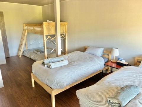 a room with two bunk beds in a room at The Glow Omachi B棟 in Omachi
