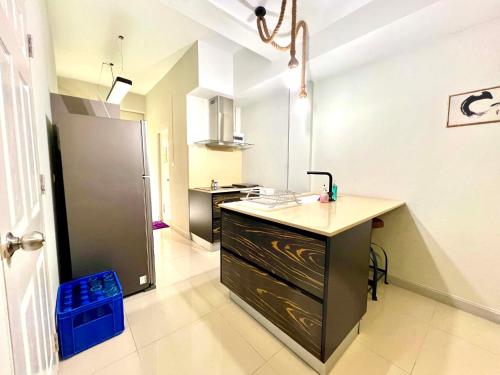 a kitchen with a sink and a counter in a room at Brianna Balcony Apartment in Ban Ton Chok