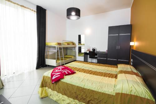 a bedroom with a large bed with a desk at Hotel Panama Majestic in Rimini