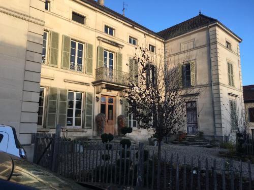 a large white house with a fence in front of it at Joie de Vivre in Doulevant-le-Château