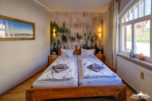 a bedroom with two beds and a large window at Auszeit im Harz Haus 1 Wohnung Feuerstein in Schierke