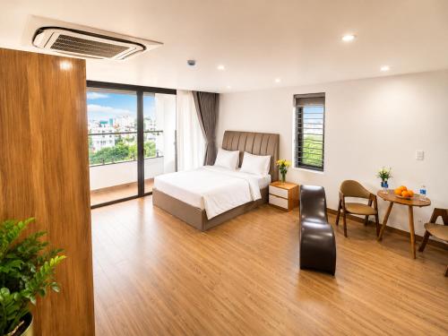 a hotel room with a bed and a table and chairs at Golden Hotel in Ho Chi Minh City