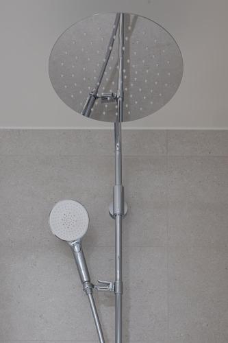 a round table with a stool under it at Hôtel Les Loges in Geneva