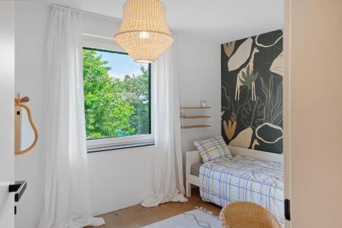 a bedroom with a bed and a window at Modern House, Pool, Garden in Burgdorf