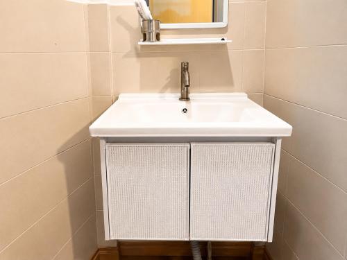 a bathroom with a white sink and a mirror at Redang Divers Resort in Redang Island