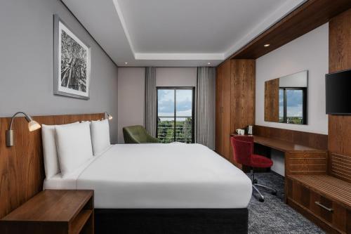 a hotel room with a bed and a desk at Holiday Inn - Nairobi Two Rivers Mall by IHG in Nairobi