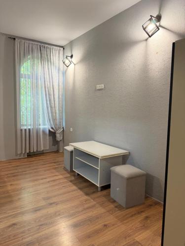 an empty room with a desk and a window at ElMar Guesthouse in Sevan