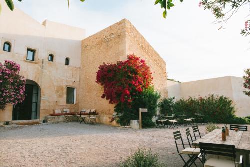 a building with red flowers on the side of it at The Lodge Mallorca, Small Luxury Hotels in Sa Pobla