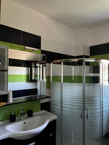 a bathroom with a sink and a glass shower at Villa iliotropio in Lefokastro