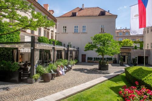 people sitting in the courtyard of a building at Mandarin Oriental, Prague in Prague