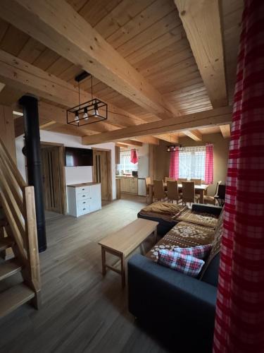 a living room with a couch and a table at Pallov Dvor in Lutiše