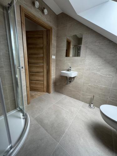a bathroom with a sink and a shower at Pallov Dvor in Lutiše