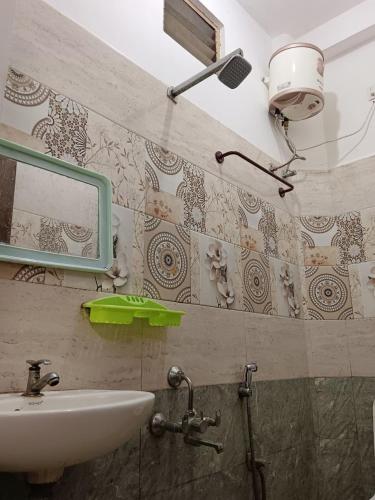 a bathroom with a sink and a mirror on the wall at De Township beach in Pondicherry