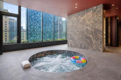 a hot tub in a room with a view of a city at Zen Sky Home - Super Centre with Free Car park & Pool in Melbourne