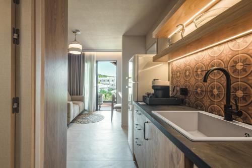 a kitchen with a sink and a counter at Palmea Suites in Pefki