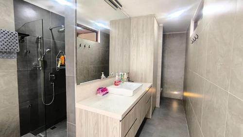 a bathroom with a sink and a shower at Eimas Hive in Kerobokan