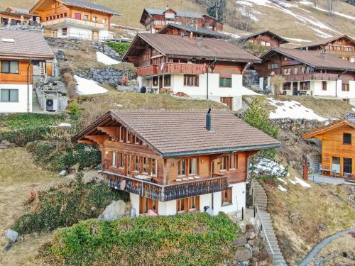 a large wooden house on top of a mountain at Luxury Alpine Chalet with incredible Views in Lenk