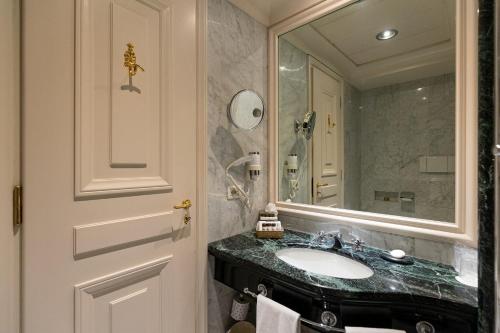 a bathroom with a sink and a mirror at Grand Hotel Sitea in Turin