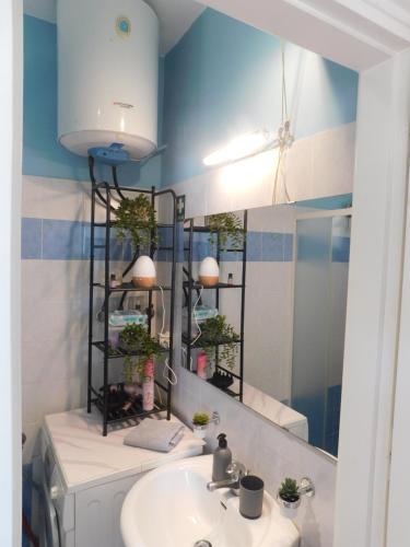 a bathroom with a sink and a mirror at PiPi's House in Nea Artaki