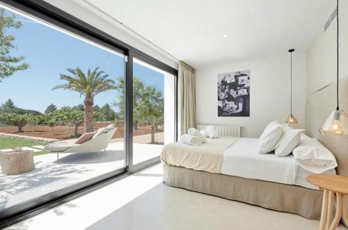 a bedroom with a bed and a large window at Can Pep De Sa Guaita in Sóller