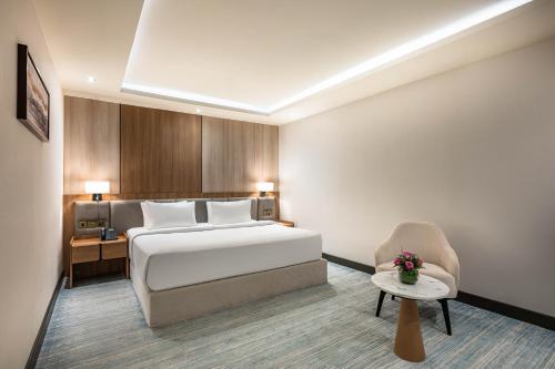 a hotel room with a bed and a chair at Sama Inn Hotel in Riyadh