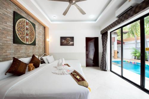 a bedroom with a bed and a pool at MM Pool Villa in Pattaya South