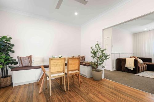 a living room with a table and chairs and a couch at Sunday Valley in Cessnock