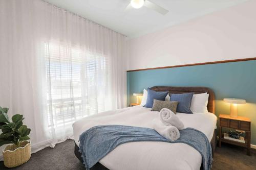 a bedroom with a large bed with towels on it at Sunday Valley in Cessnock