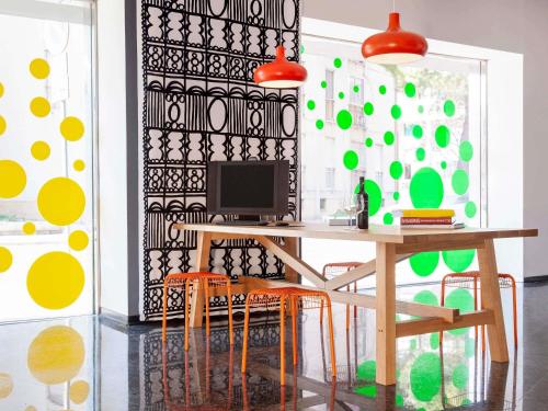 a room with a desk with chairs and a computer at Ibis Styles Brindisi in Brindisi