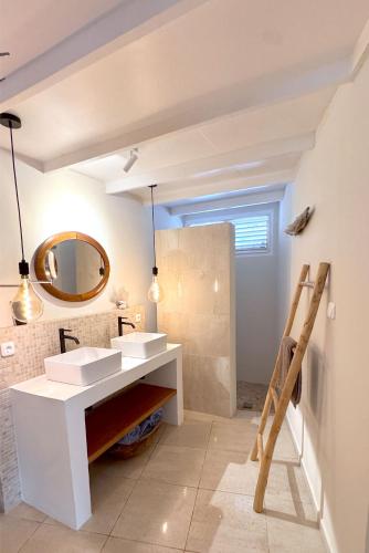 a bathroom with two sinks and a mirror at Piscadera Bay Resort 79 in Willemstad