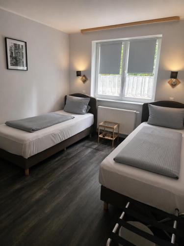 a room with two beds and a window at Lieth-Hotel-Grünreich in Bad Fallingbostel