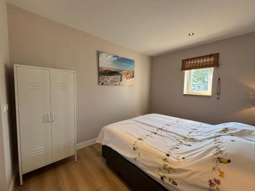 a small bedroom with a bed and a window at Sea Cottage in Westerland