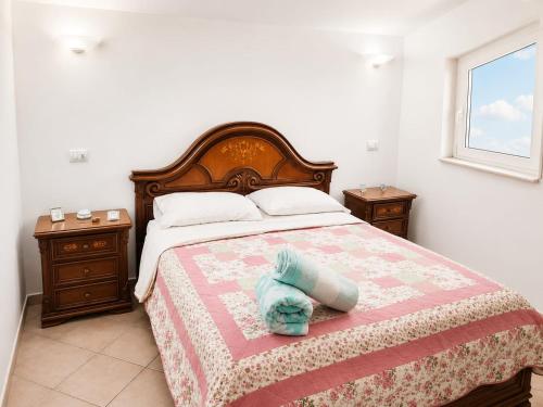 a bedroom with a bed with a blue stuffed animal on it at MANSARDA COSTA BIANCA - Free Parking in Realmonte
