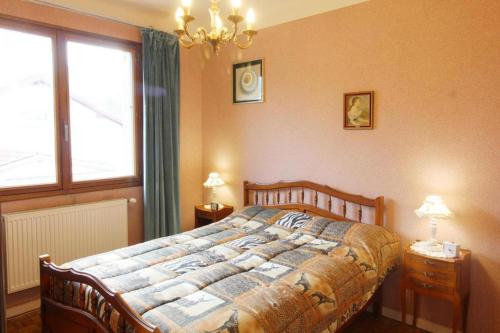 a bedroom with a large bed and a window at Charmante maison Corisande in Gerde