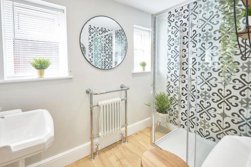 a bathroom with a shower and a sink at The Hampton Garden in Whitby