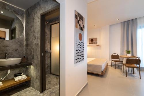 a hotel room with a bed and a bathroom at Elpis Studio Apartments in Bali